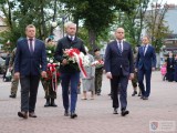 Starosta Piotr Chęciek, wicestarosta Adam Pieniążek, przewodniczący Michał Maziarka składają kwiaty